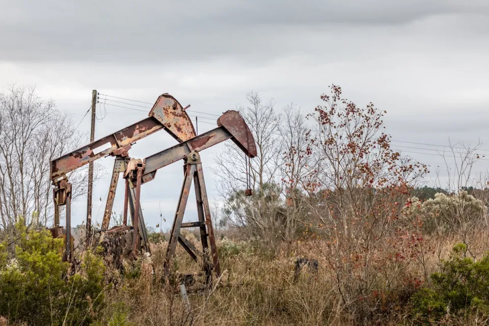 Two rusty, abandoned oil pumps in rural Texas.
